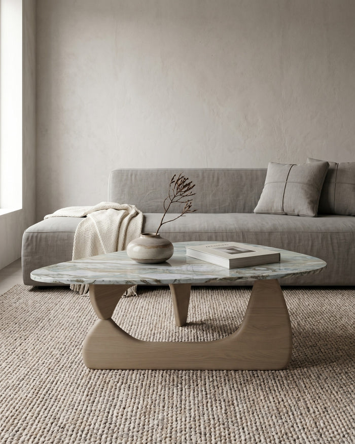 Modern living room with a gray sofa and marble coffee table.